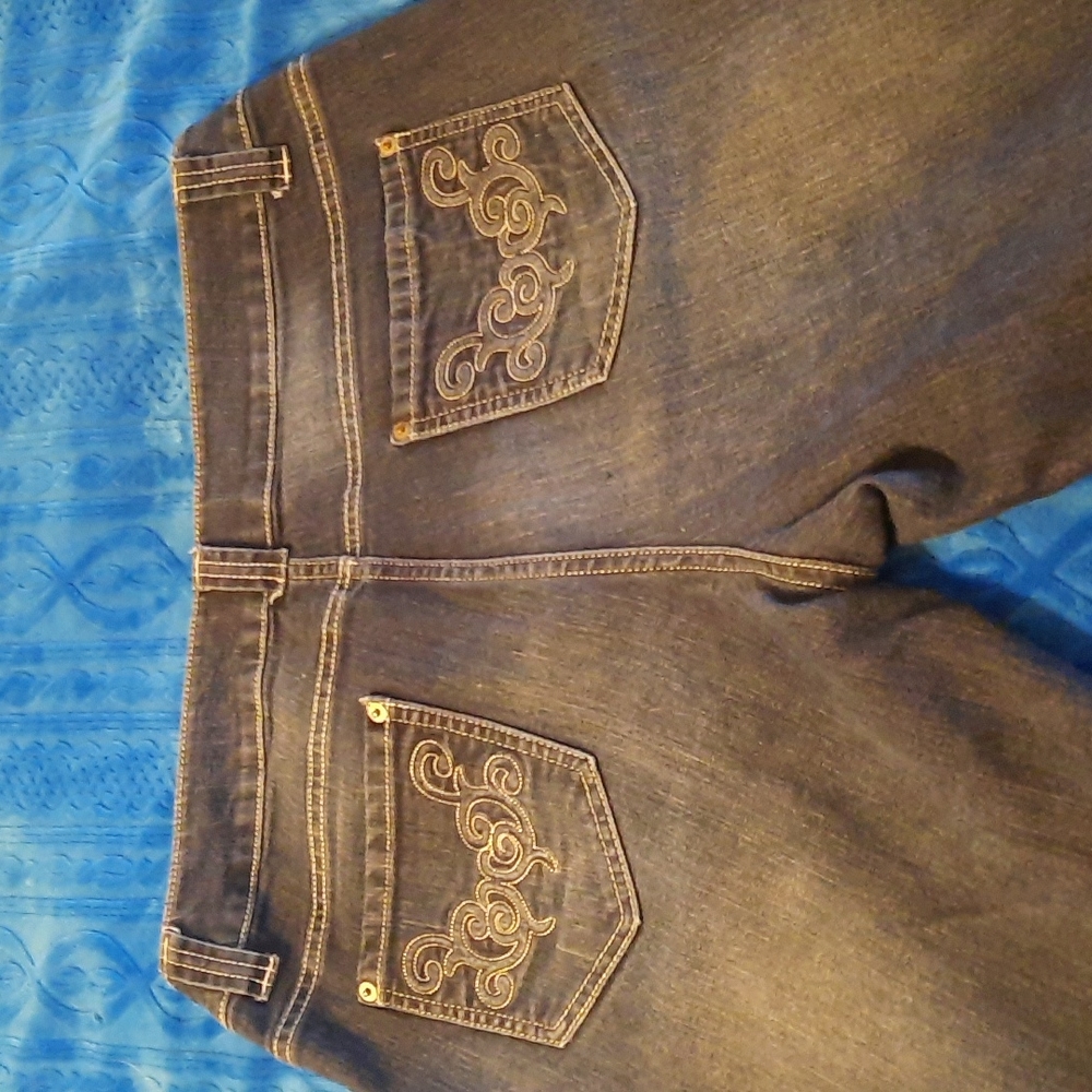 Dark wash boot cut jeans with embellished pockets
